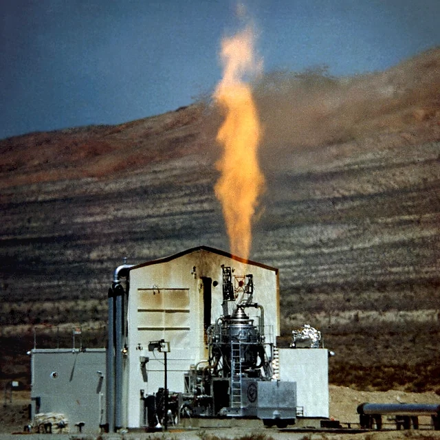 Kiwi nuclear rocket firing on a desert test stand.